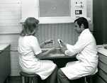  Laboratory assistant Tuula Peltonen and microbiologist Heikki Kakko transplanting microbe stock into fresh culture medium at the Jämsänkoski Pekilo plant in 1980.  